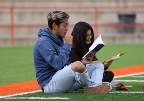 During the read across the district event on Nov. 8, seniors Sebastian Calderon and Denise Mendoza participate along with hundreds of other students in the field of R.R. Jones Stadium. 