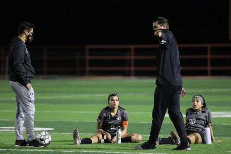 Seniors Lauren Lara (left) and Brianna Galvan discuss halftime adjustments with head coach Peter Fargo (center) and assistant coach Ryan Rodriguez during the Feb. 10 match up against Chapin.