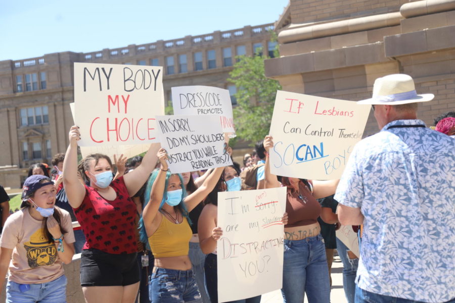 A small group of students are shown protesting the schoo’ls dress code policy during the lunch pep rally on Aug. 27.