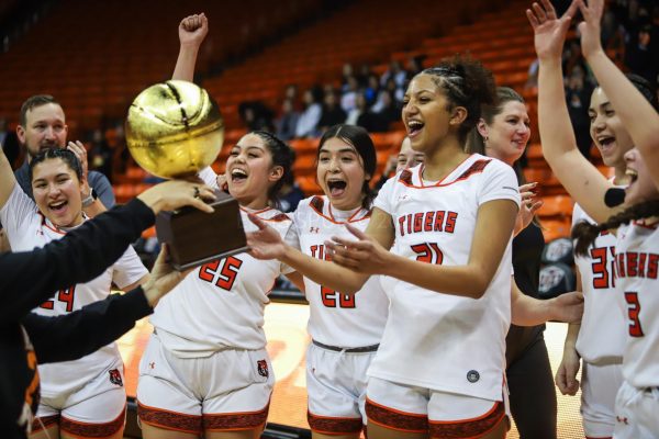 Maya Morales, Jacqueline Carrera, Jazmin Torres and Natalia Thomas celebrate with the rest of their team as theyre presented the 5A bi-district trophy after defeating Del Valle on Feb. 13. 