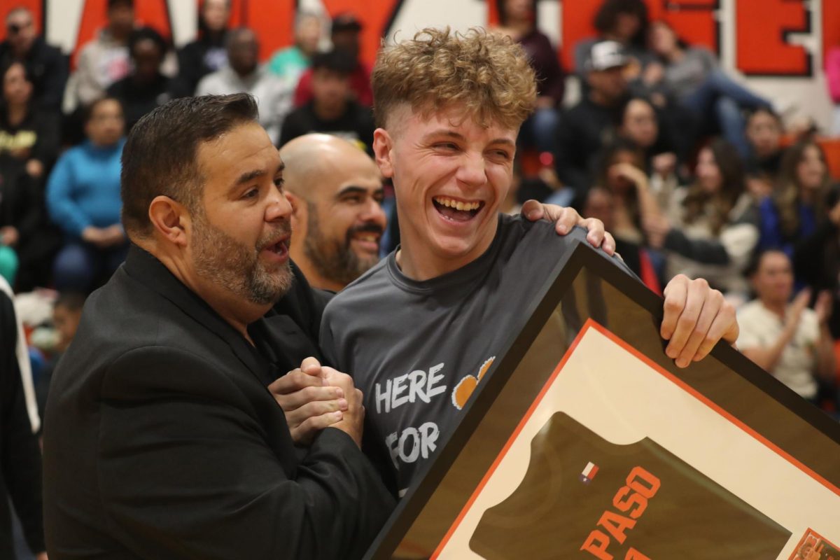 Senior Brody John shares a laugh with assistant coach, Ruben Sanchez, during the senior night presentation on Dec. 13, 2024.